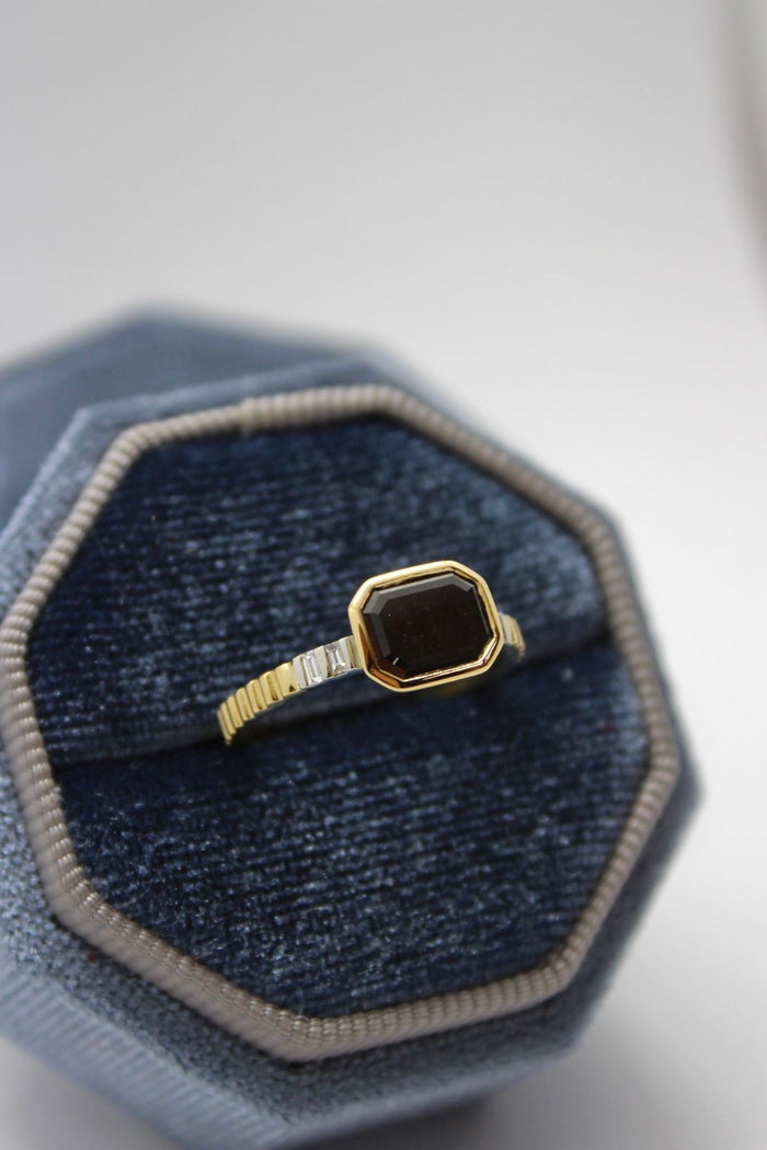 A bespoke black diamond ring set in 18 carat yellow and white gold