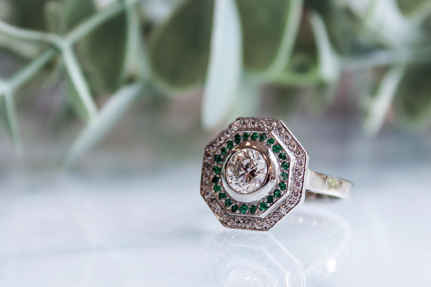 Platinum diamond and emerald target ring art deco style