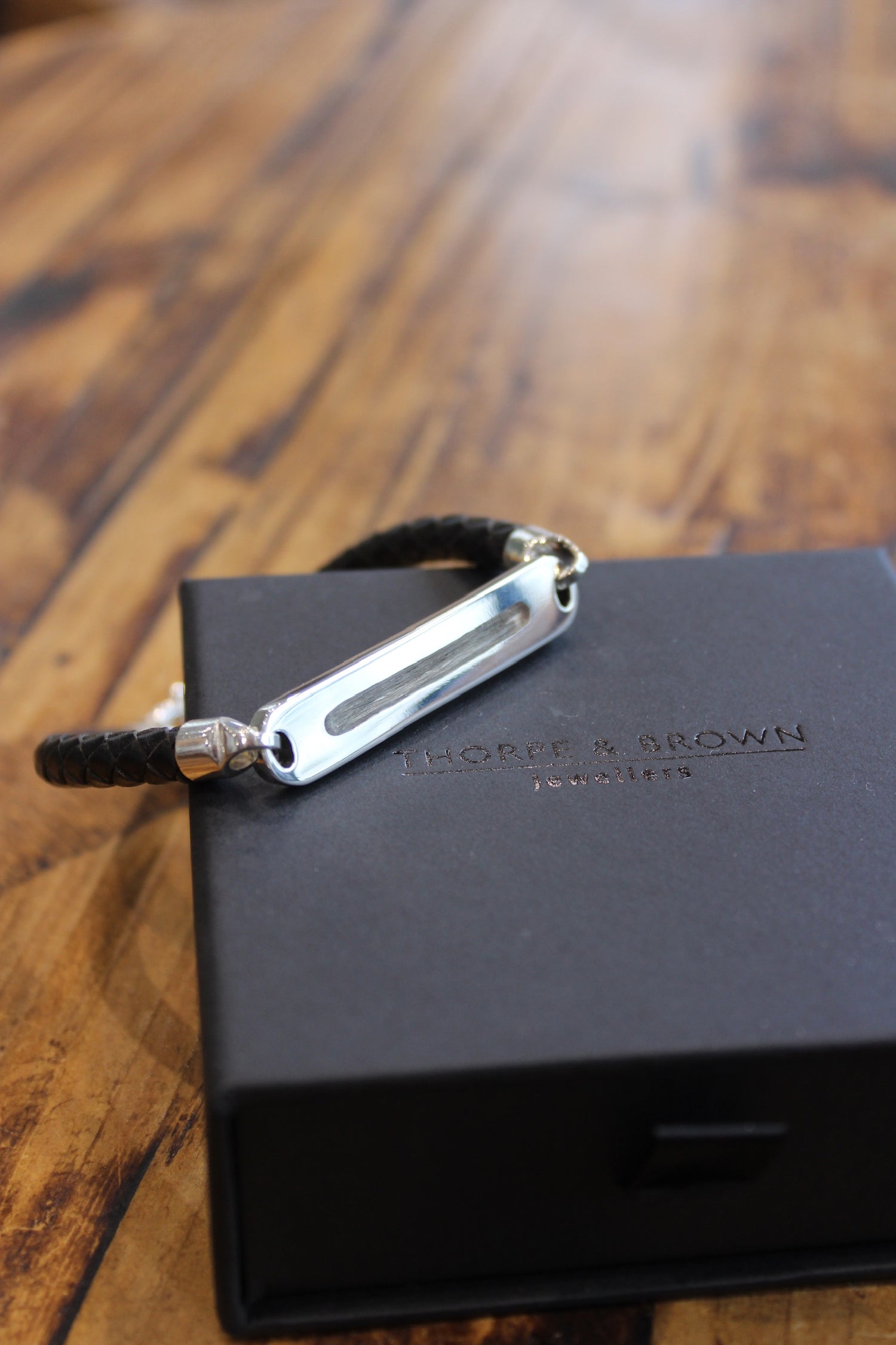 Memorial gents bracelet with hair set in resin, made in silver & leather